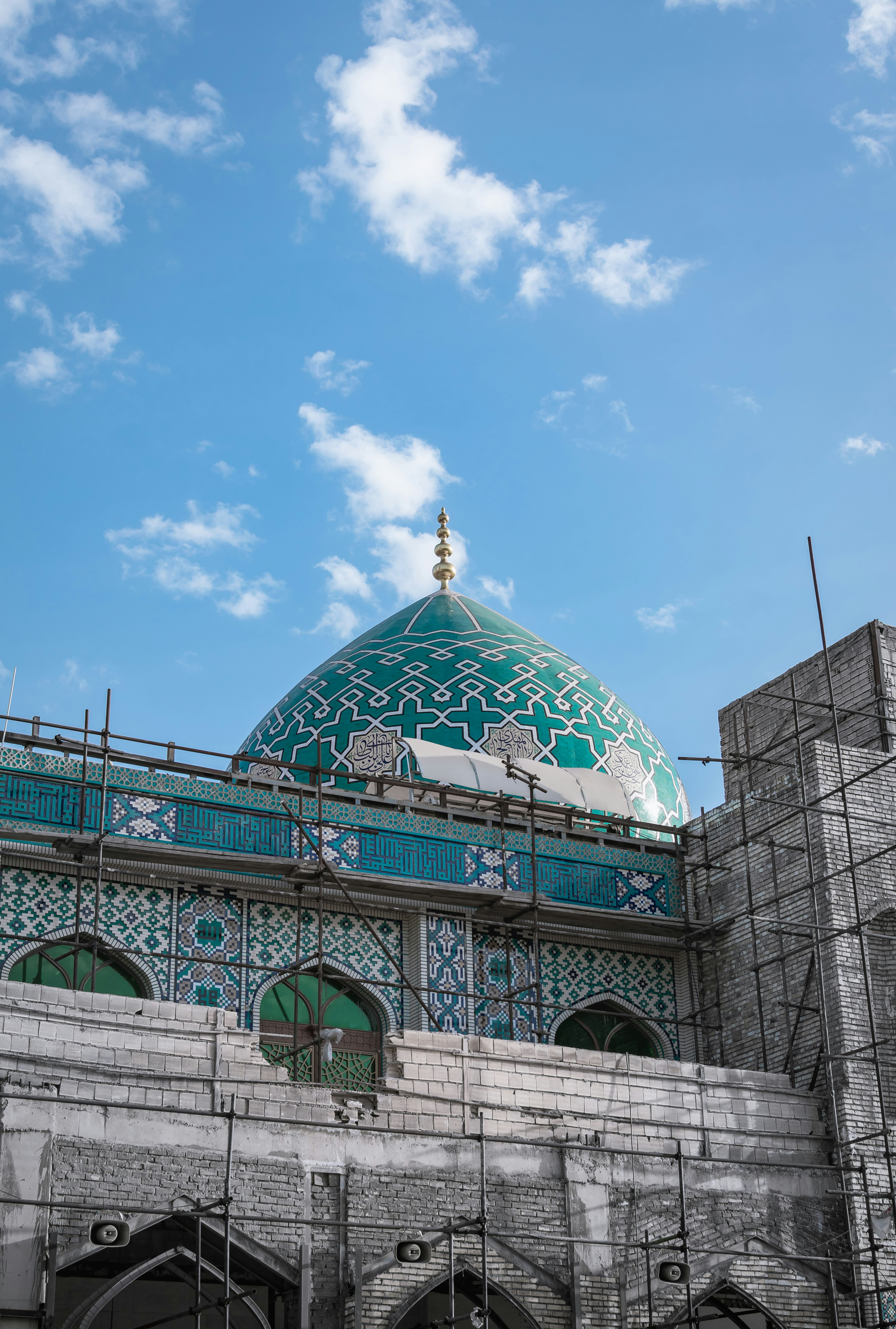 gray and blue building with dome under blue sky